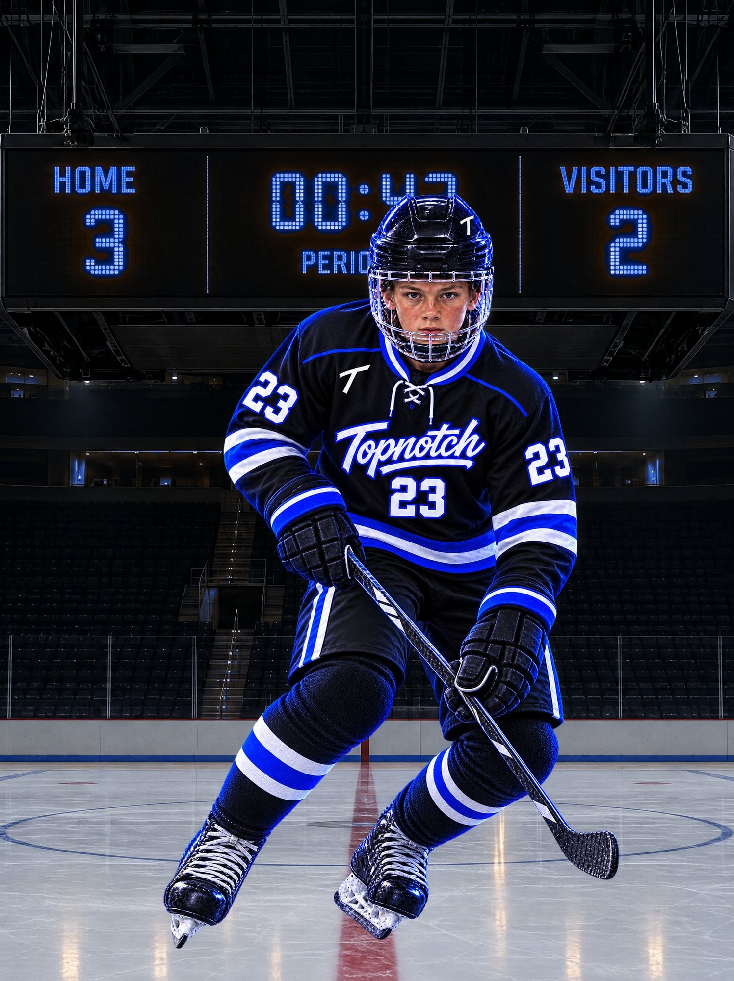Hockey player in a black, white and electric-blue Topnotch number 23 kit turning on the ice beneath a blue LED scoreboard